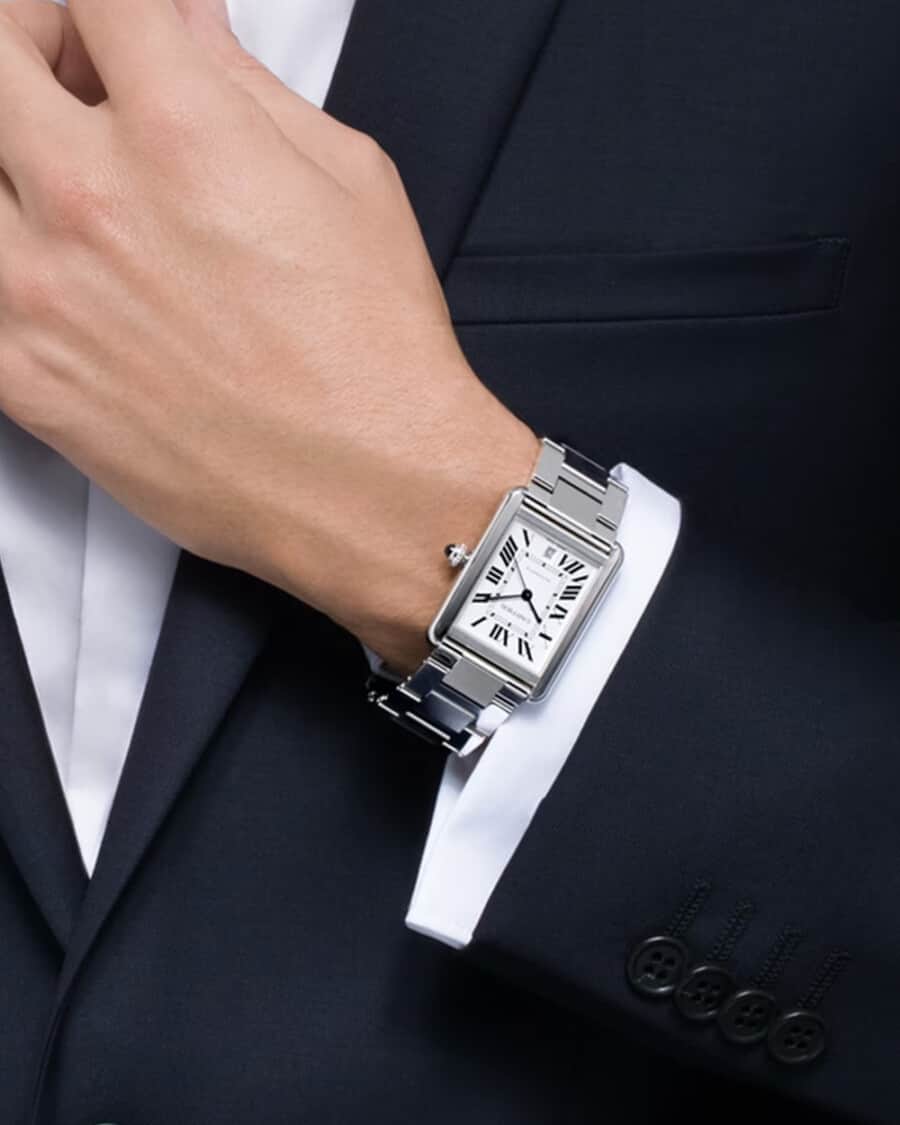 Cartier Tank Solo XL worn on wrist with a shirt and suit