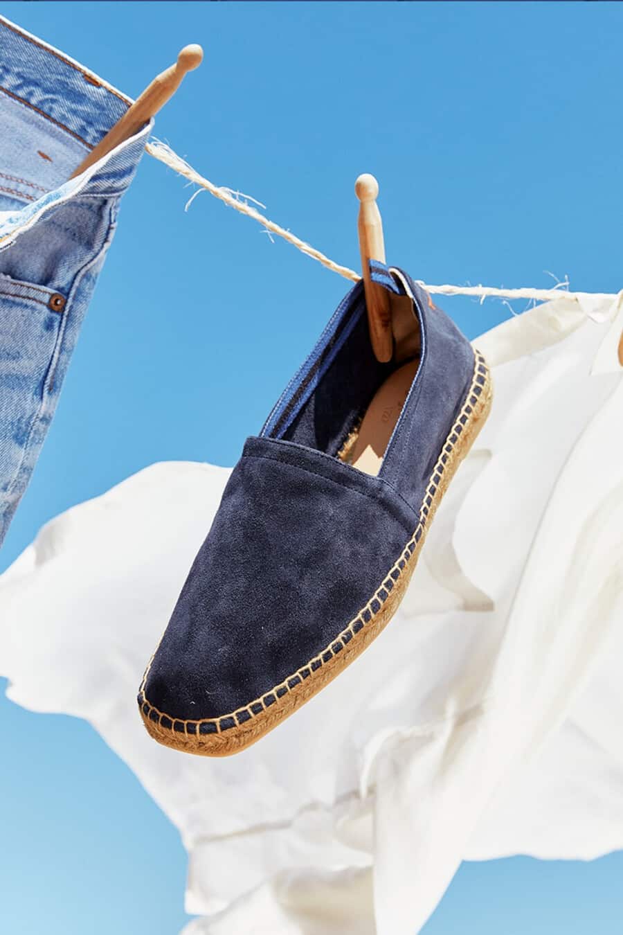 Men's blue suede Castaner espadrille hanging on washing line
