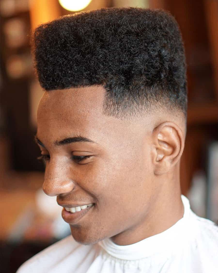 Black man with modern afro flat top hair cut and low skin fade