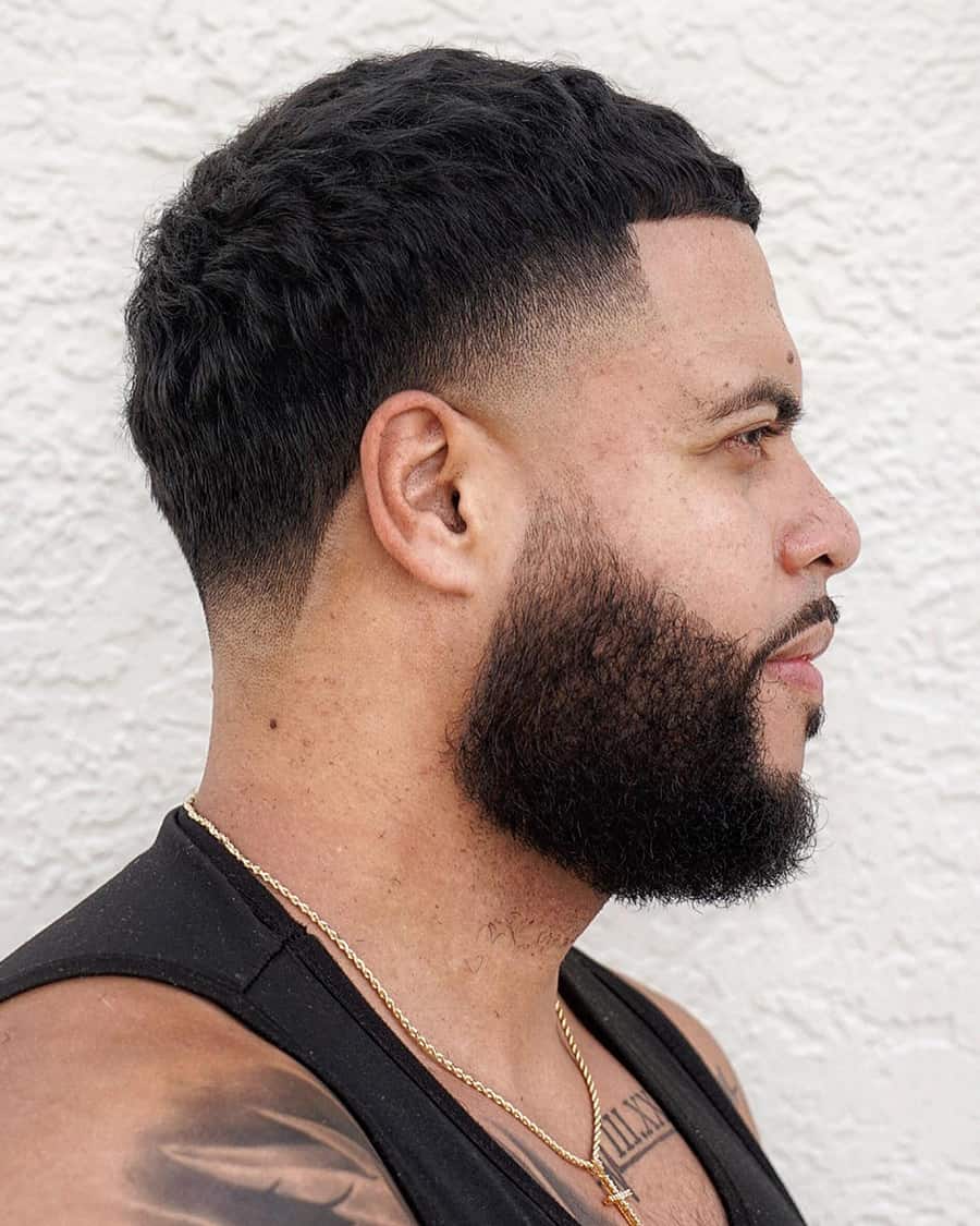 Round face man with short French crop/Caesar cut and a low skin fade