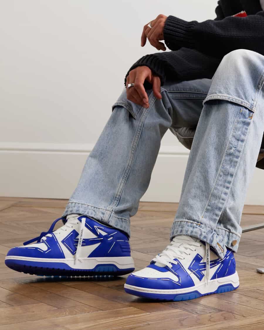 Men's blue and white OFF-WHITE out of office sneakers worn on feet with pale wash jeans