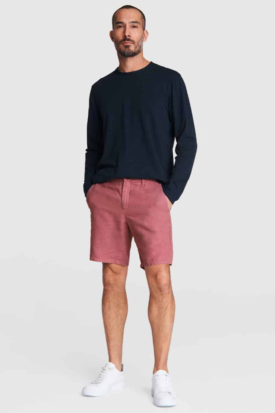 Men's pink shorts, long sleeve navy T-shirt top and white sneakers outfit