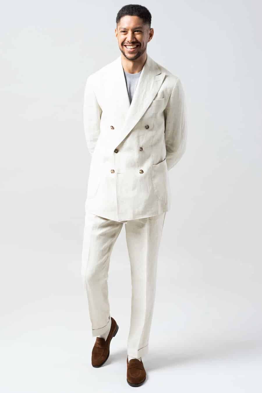 Men's ivory double-breasted linen suit, grey T-shirt and brown suede penny loafers outfit