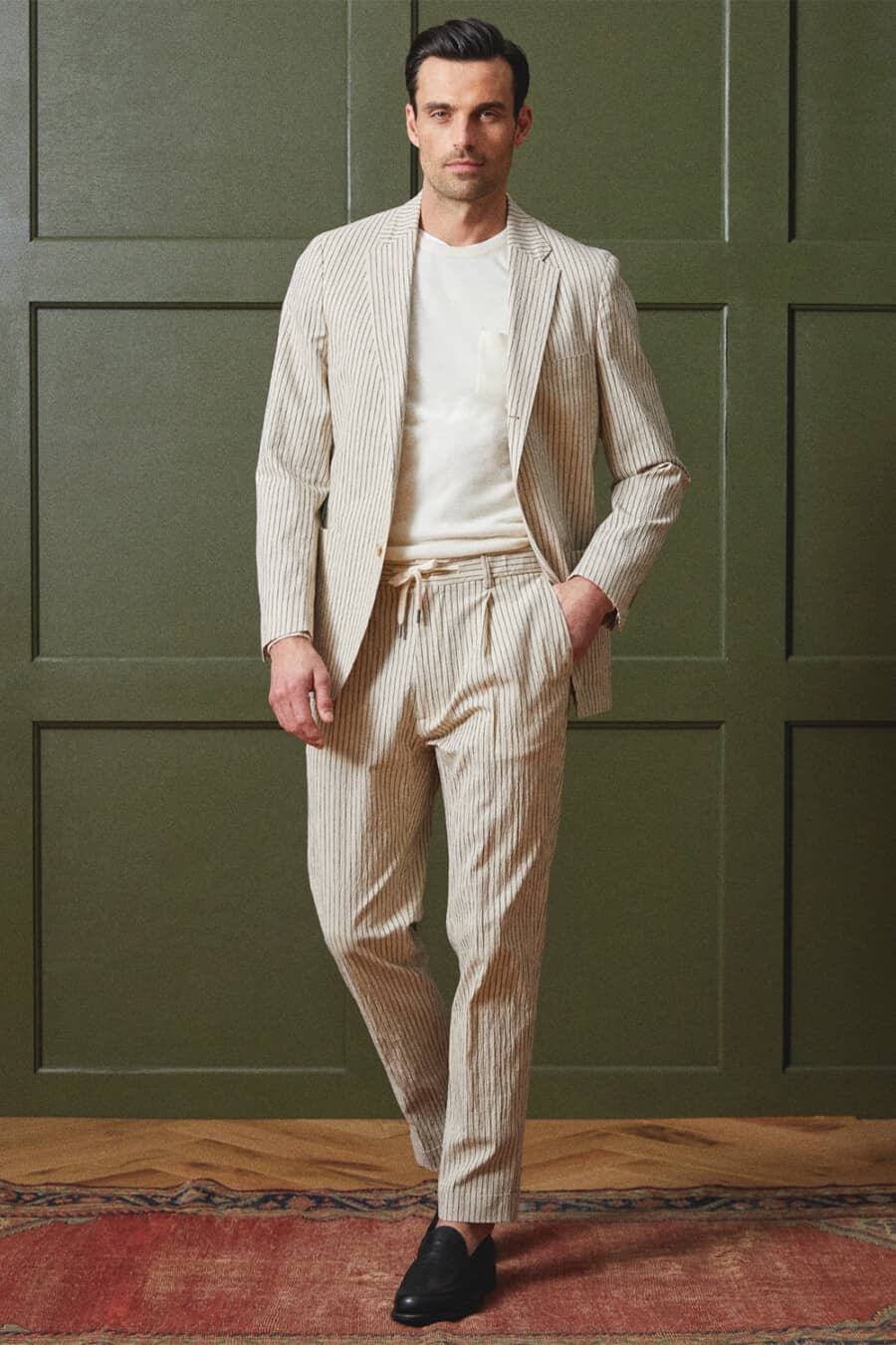 Men's cream striped drawstring suit, white T-shirt and black leather loafers outfit