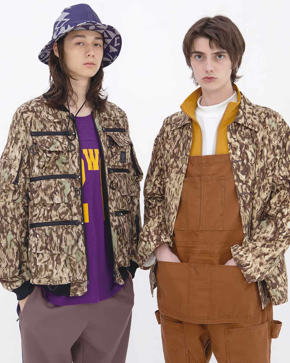 Two men wearing workwear and camo jackets by South2 West8