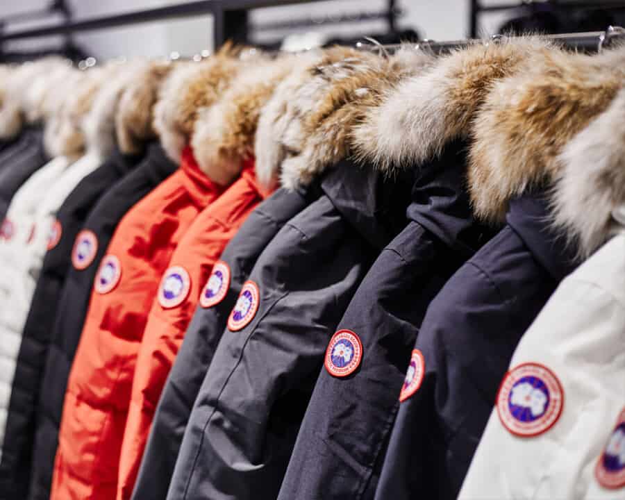 A rack of men's Canada Goose parka jackets in multiple colours
