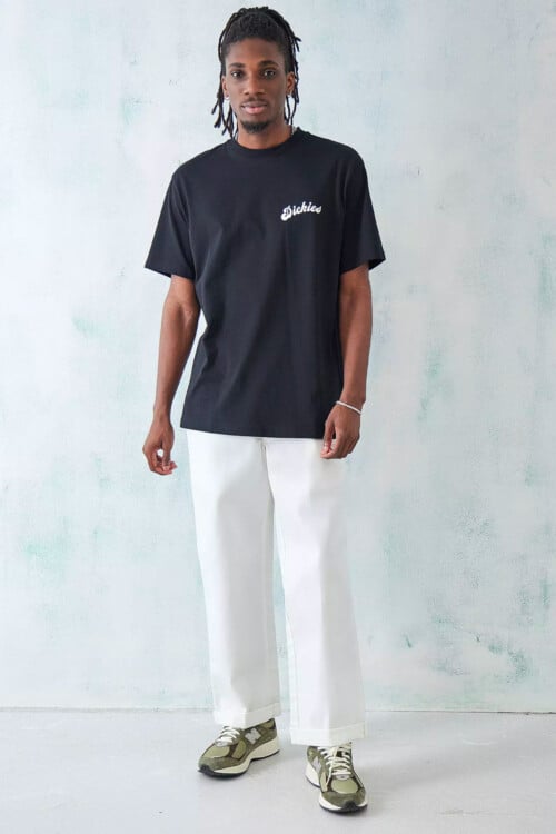 Men's black logo printed T-shirt by Dickies, white loose pants and New Balance running sneakers outfit