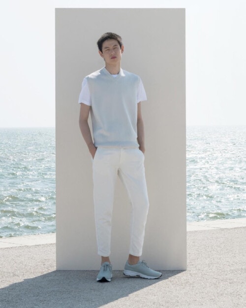 JAK S03 sneakers worn on feet with cropped white pants, white T-shirt and sky blue sweater vest