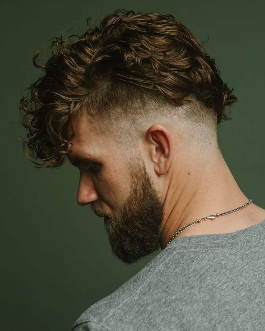 Man with long curly/wavy hair and taper fade for modified mohawk