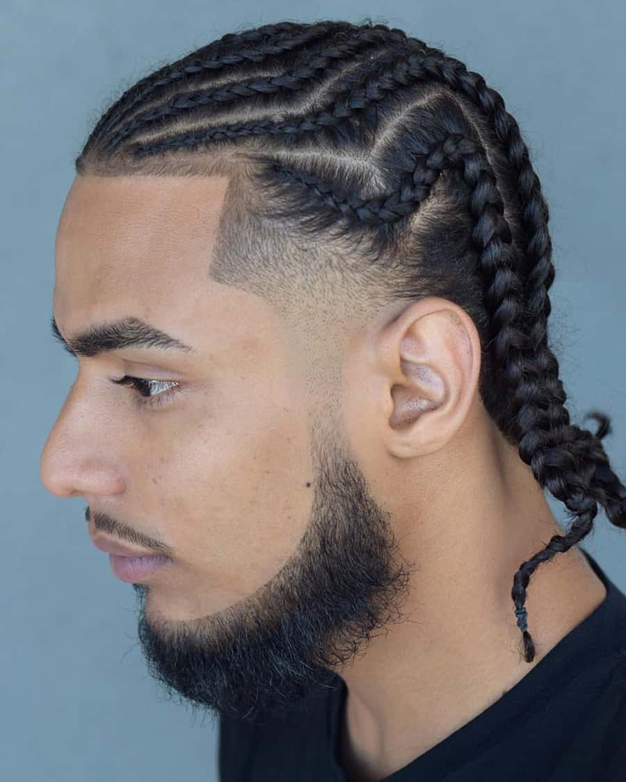 Black man with long braids and a temple skin fade
