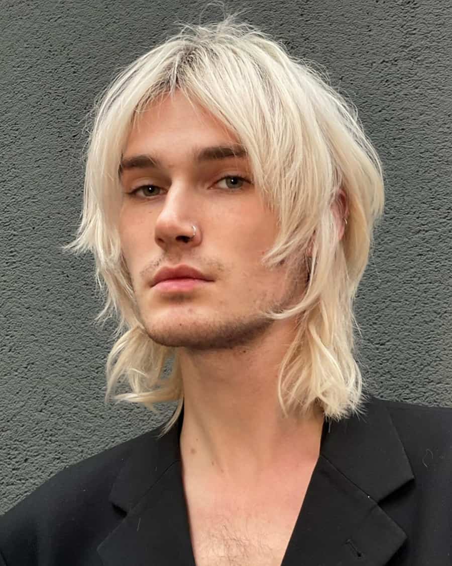 Men's long length bleached blonde wolf haircut