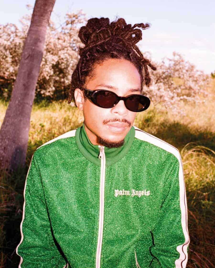 Man wearing a green Palm Angels tracksuit which fits true to size