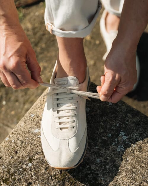 Man tying a pair of smart Velasca Rodich sneakers