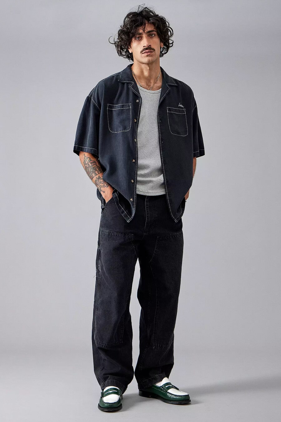 Men's black baggy jeans, grey vest, denim short sleeve mechanics shirt and spectator loafers outfit