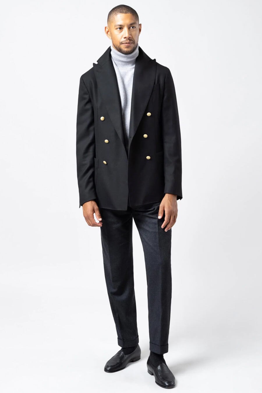 Men's navy pants, sky blue turtleneck, oversized navy double-breasted blazer and black leather Belgian loafers outfit
