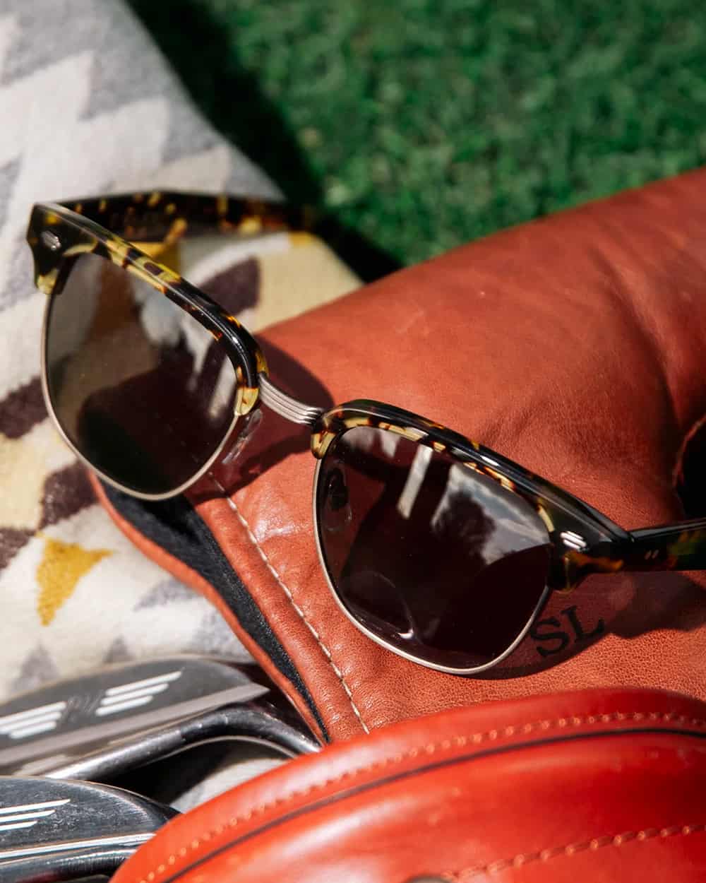 Close up of a pair of tortoiseshell Garrett Leight Wayfarer style sunglasses