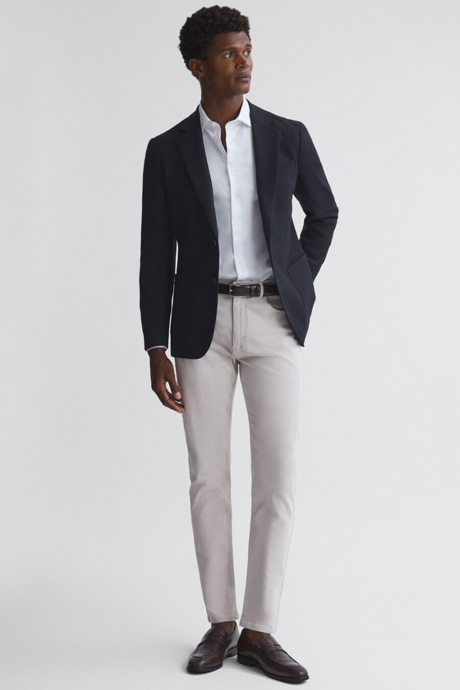 Navy single-breasted blazer, light grey jeans, white shirt, brown leather belt and brown leather sockless penny loafers outfit