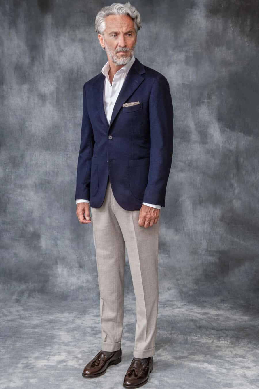 Men's navy blazer, white shirt, light grey tailored pants, grey socks and brown leather tassel loafers outfit