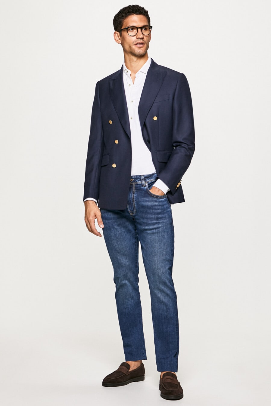 Navy double-breasted blazer, mid-wash jeans, white shirt and brown suede penny loafers worn sockless outfit