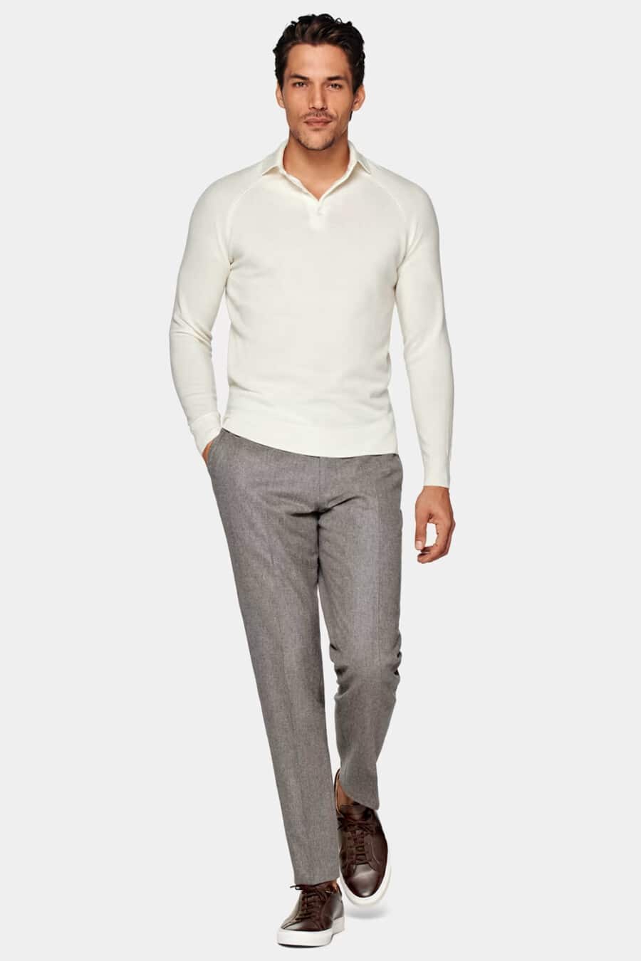 Men's grey tailored pants, white long-sleeve knitted polo shirt and brown leather sneakers worn sockless outfit