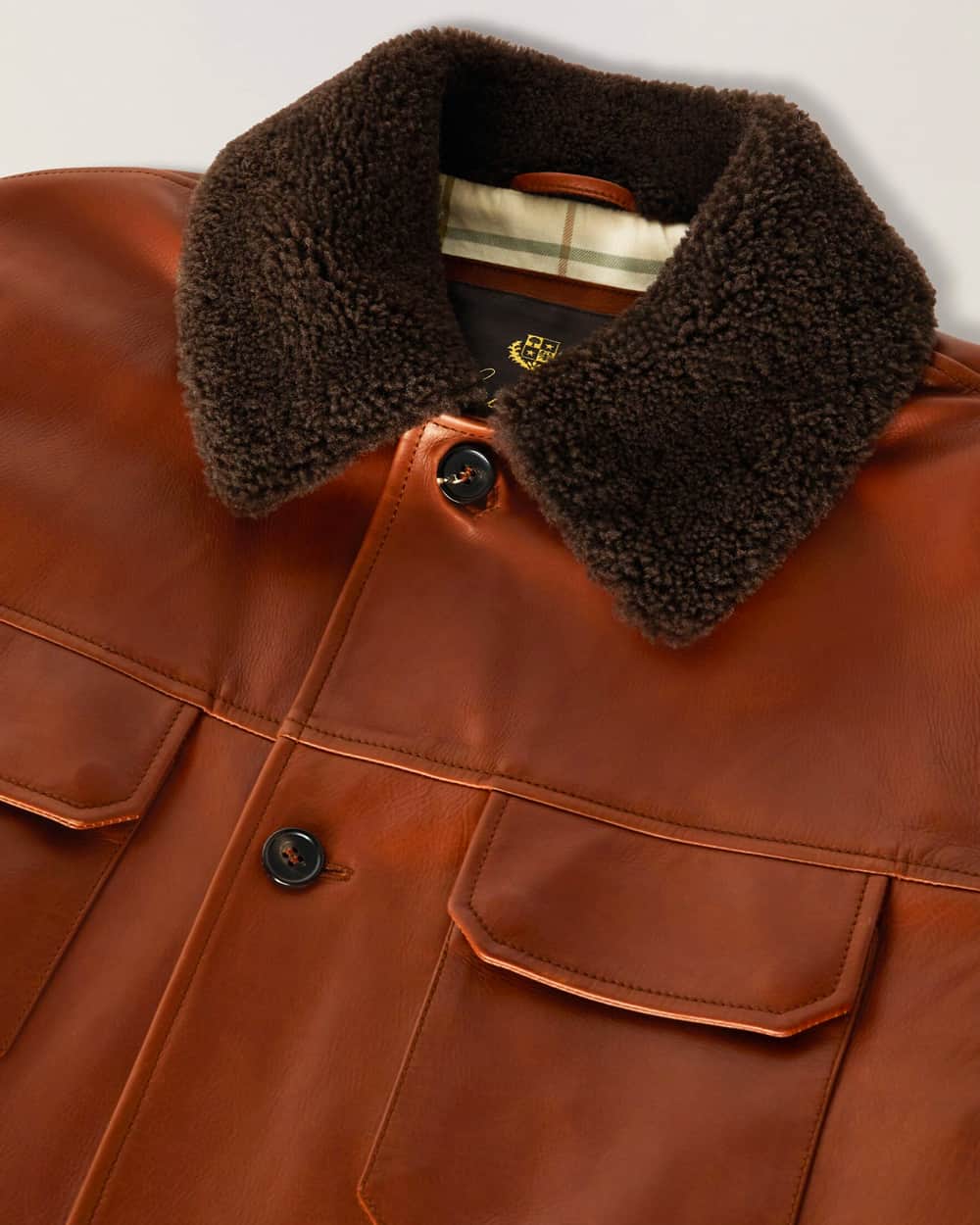 Close up of Loro Piana tan leather jacket with shearling collar