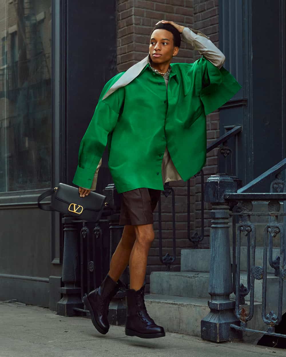Man wearing Valentino green jacket, brown leather shorts and black leather boots