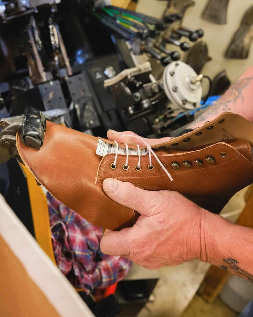 Shoemaker sculpting a boot upper in a traditional way