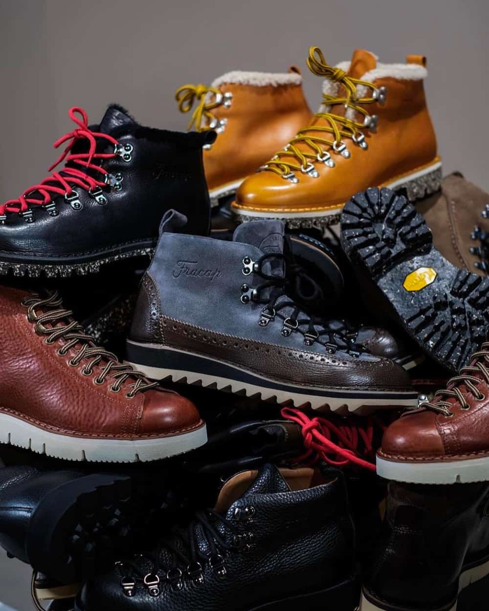 Fracap men's leather hiking boots in multiple colorways sitting in a pile