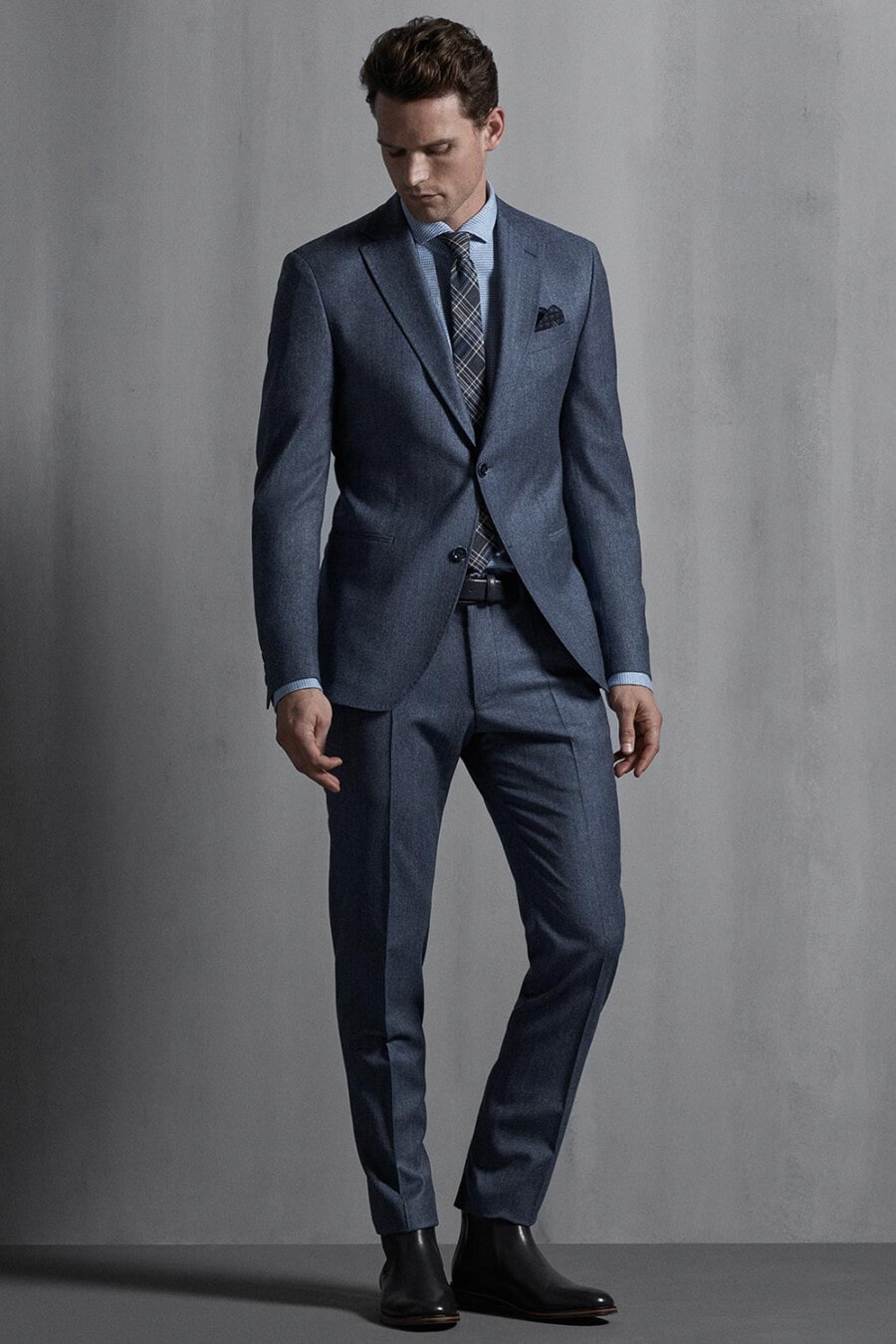 Men's Grey-blue suit, light blue shirt, grey check tie and black leather Chelsea boots