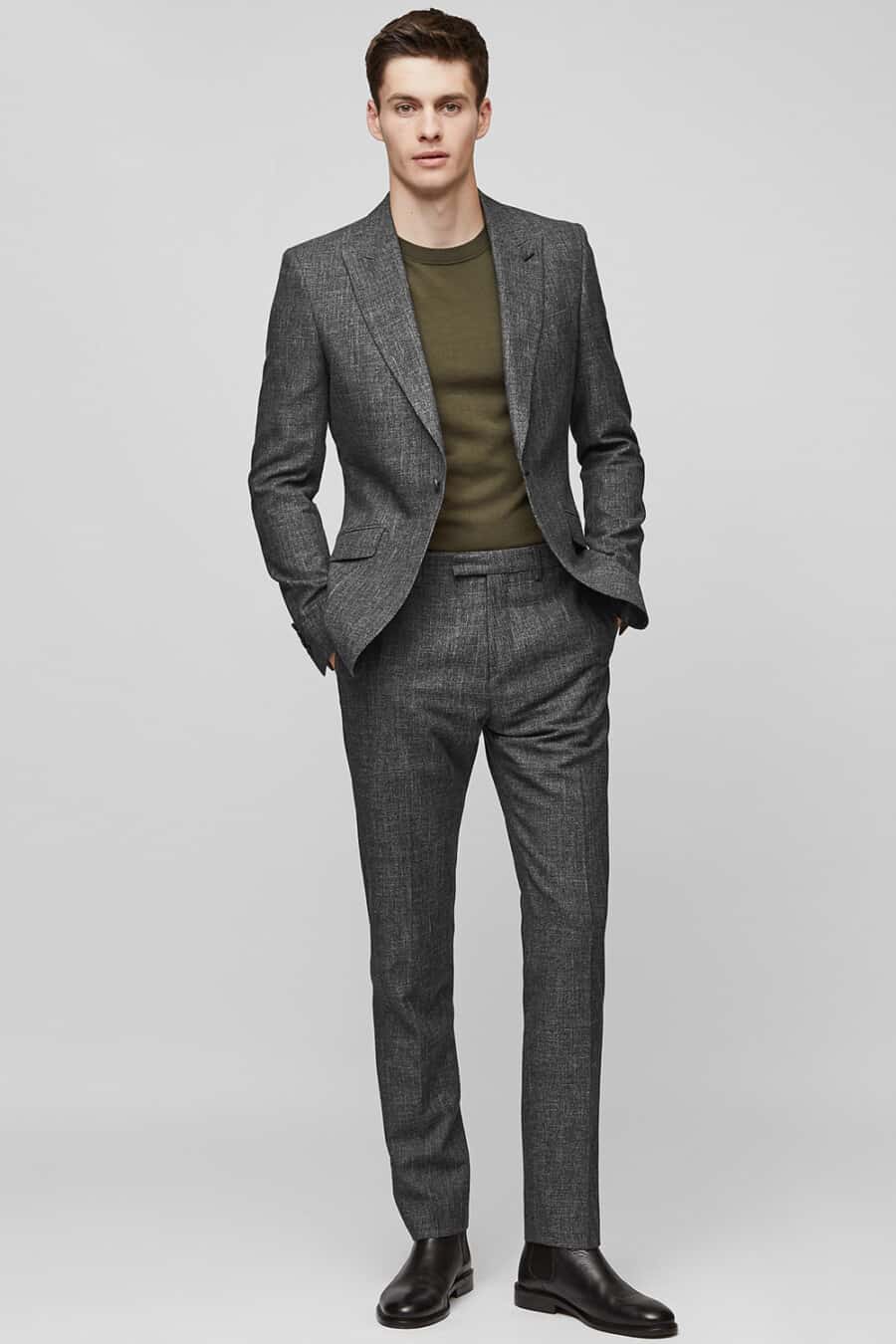Men's textural charcoal suit, green T-shirt and black leather Chelsea boots outfit