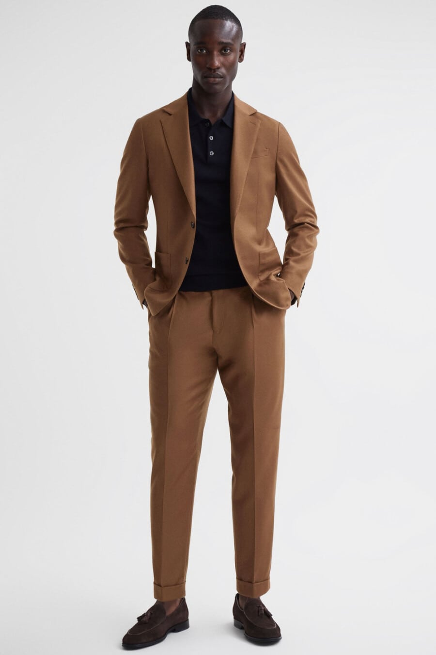Men's brown suit, black polo shirt and brown suede tassel loafers outfit