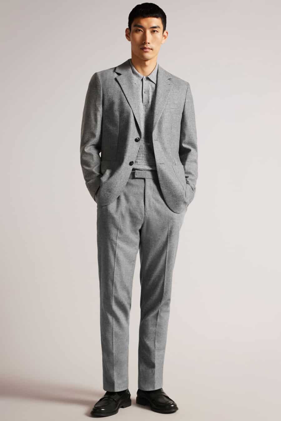 Men's grey suit, grey knitted long-sleeve polo shirt and black leather penny loafers outfit