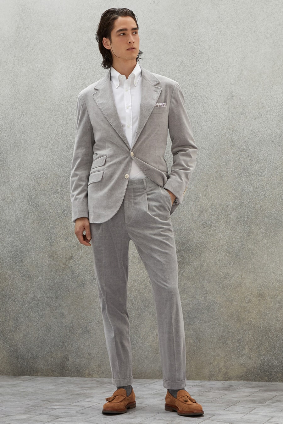 Men's grey corduroy suit, white shirt, charcoal socks and tan suede tassel loafers outfit