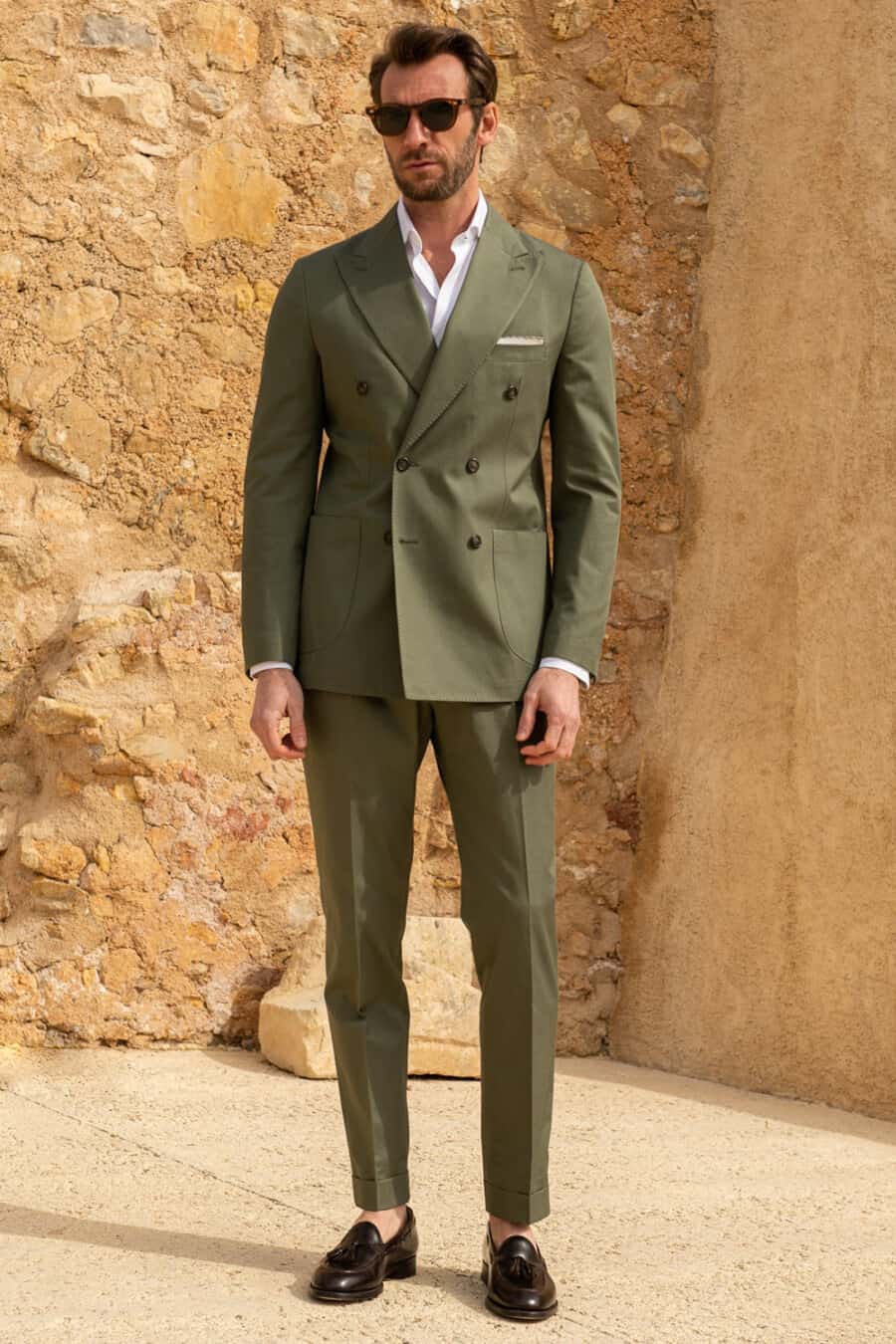 Green double-breasted suit, white shirt, tortoiseshell sunglasses and dark brown leather tassel loafers worn sockless outfit