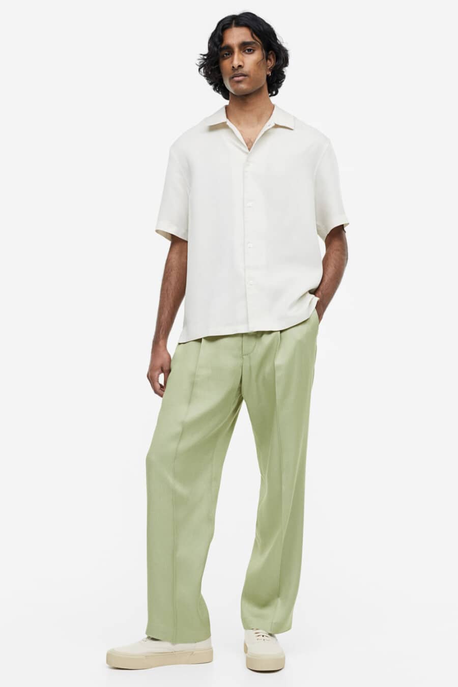 Men's light green wide-leg pants, white short sleeve shirt and chunky white canvas sneakers outfit