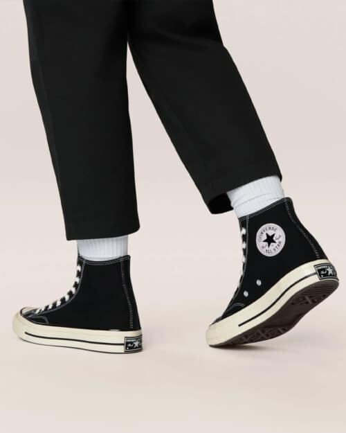 Black Converse Chuck 70 Vintage Canvas Sneakers worn on feet with white socks and cropped black pants