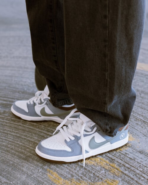 Yuto Horigome x Nike SB Dunk Low 'Wolf Grey' worn on feet with loose black jeans