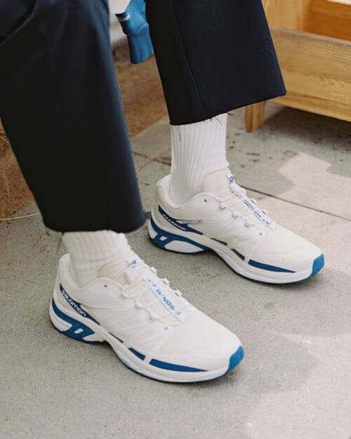 JJJJound x Salomon XT-Wings 2 'Lapis Blue' sneakers worn on feet with white socks and navy pants