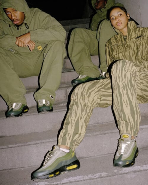 Three people all wearing camo and khaki green with Corteiz x Nike Air Max 95 SP 'Gutta Green' sneakers on feet