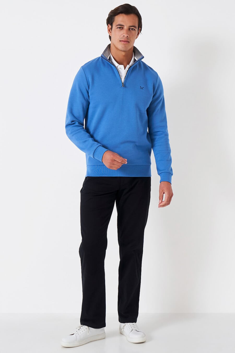 Men's black pants, white shirt, royal blue quarter-zip sweater and white sneakers outfit