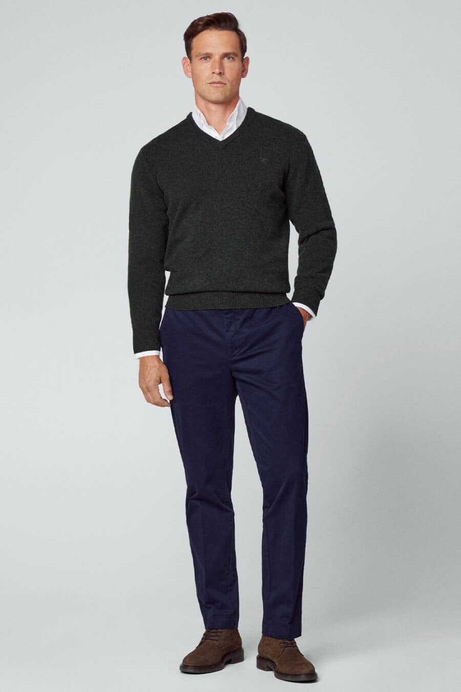 Men's navy chinos, white shirt, charcoal V-neck merino sweater and brown suede shoes outfit