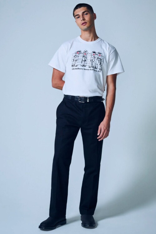 Men's navy pants, white printed tucked in T-shirt and black boots outfit