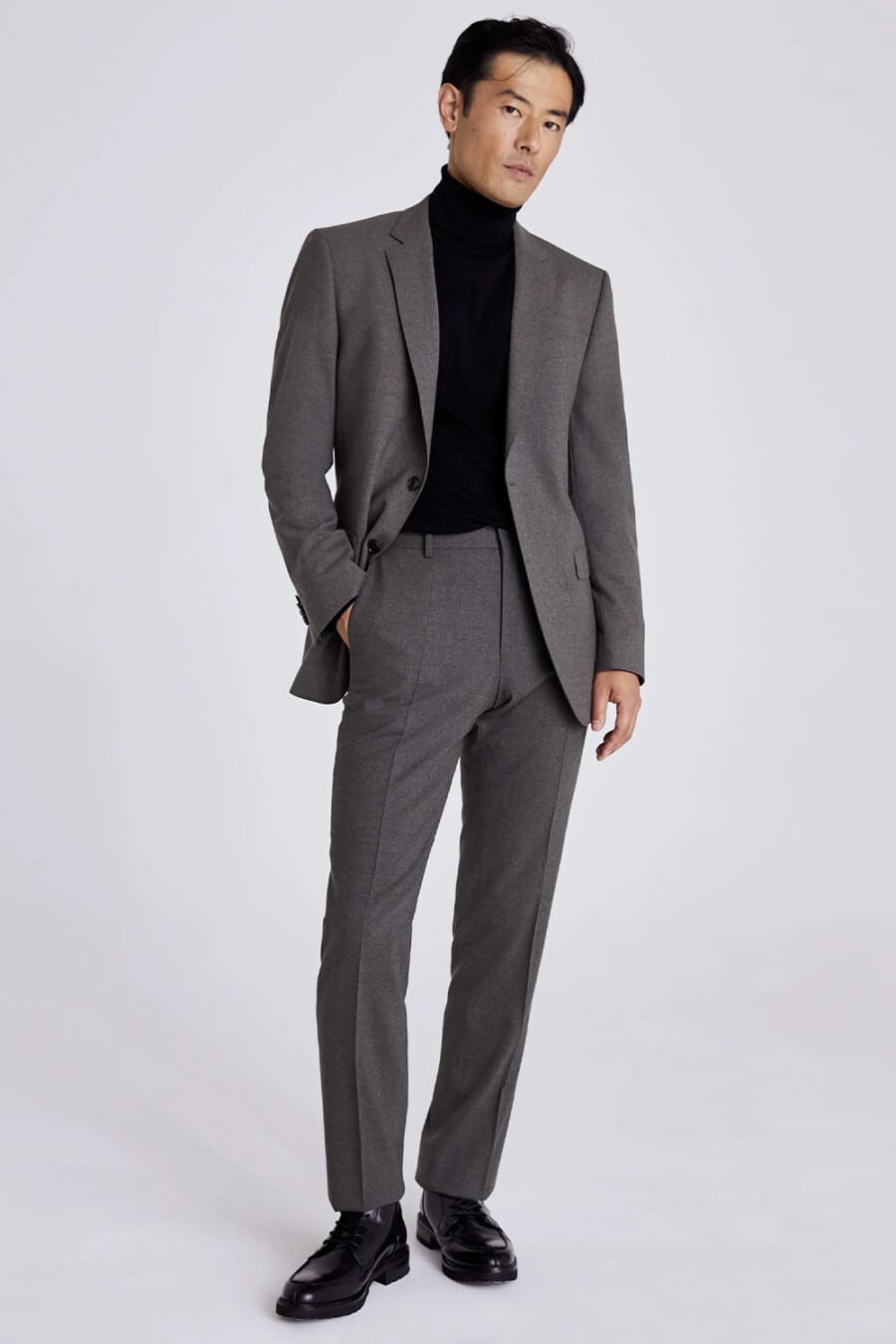 Men's charcoal suit, black turtleneck and black leather boots outfit
