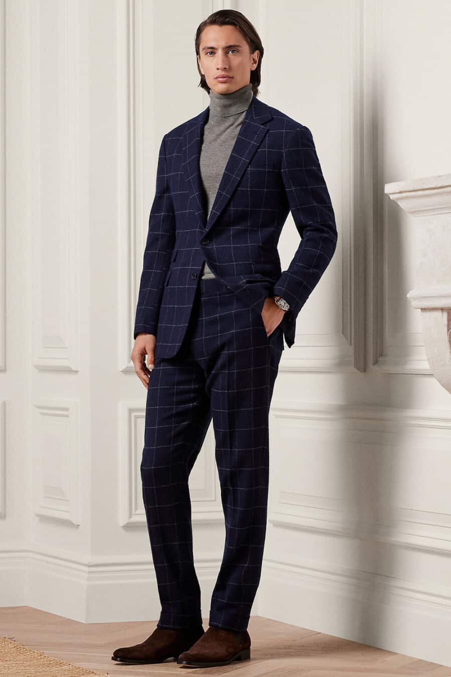 Men's navy windowpane check suit, grey turtleneck and brown suede Chelsea boots outfit