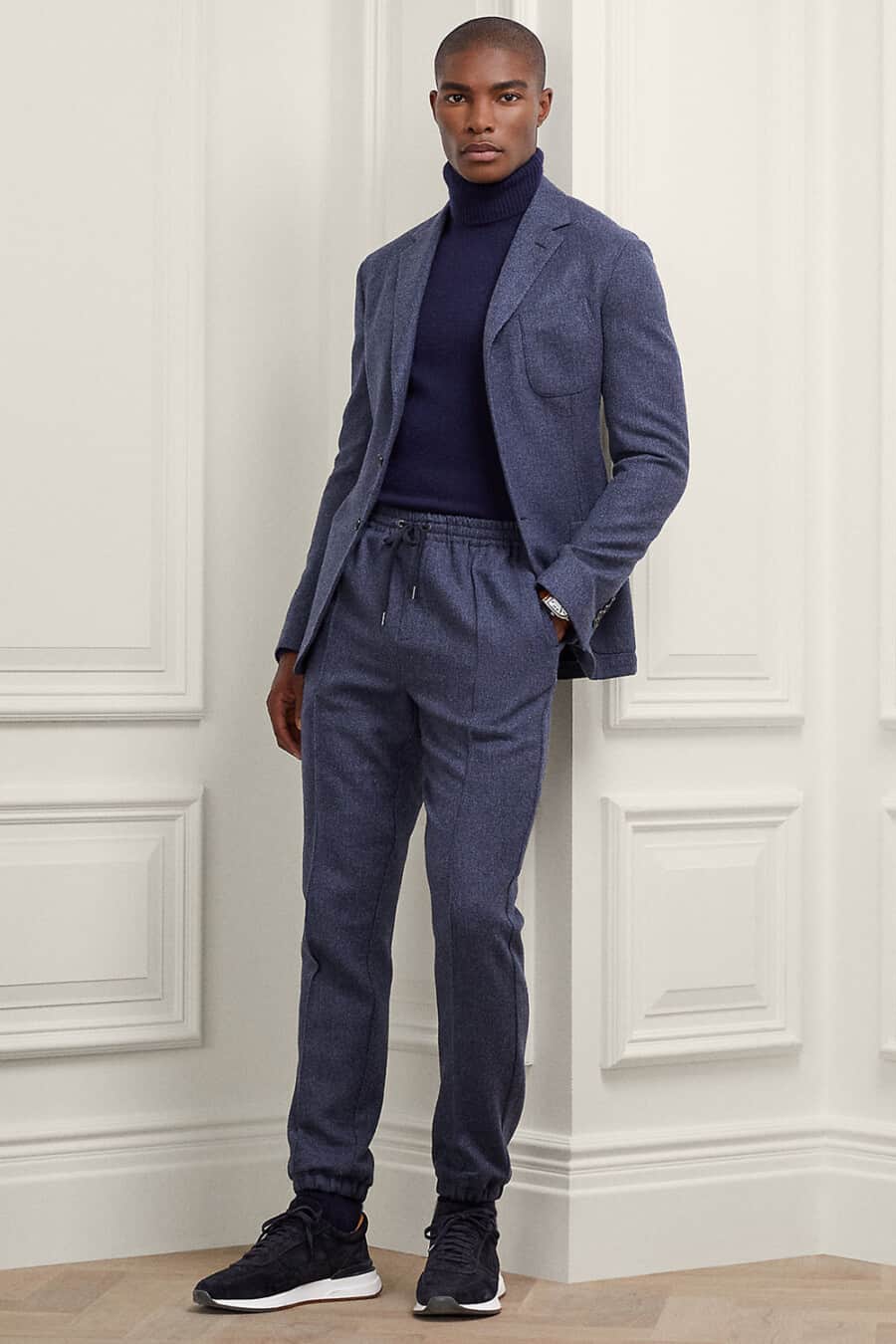 Men's mid blue drawstring suit, navy turtleneck and navy sneakers outfit