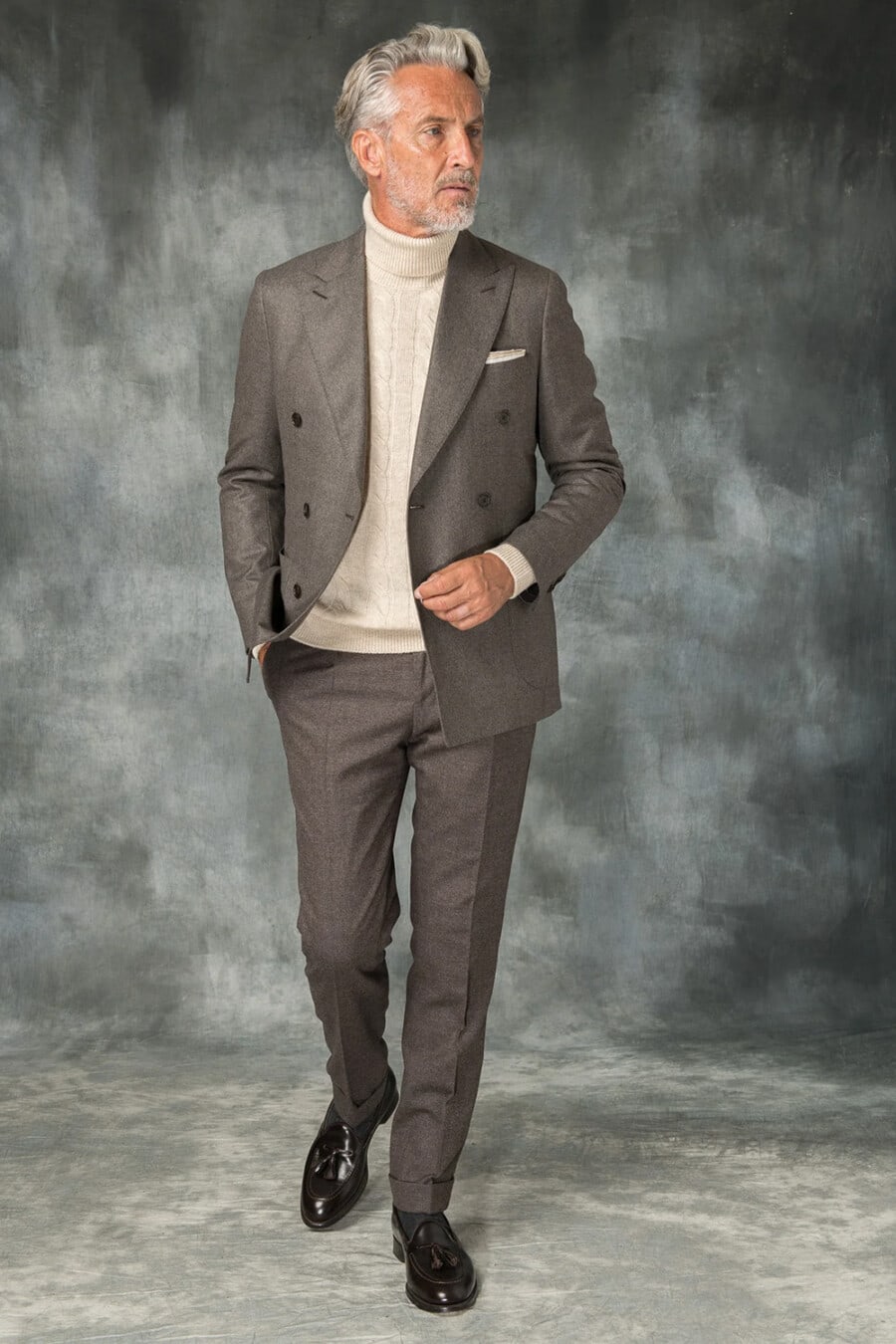 Men's grey double-breasted suit, cream cable-knit turtleneck and brown leather tassel loafers outfit