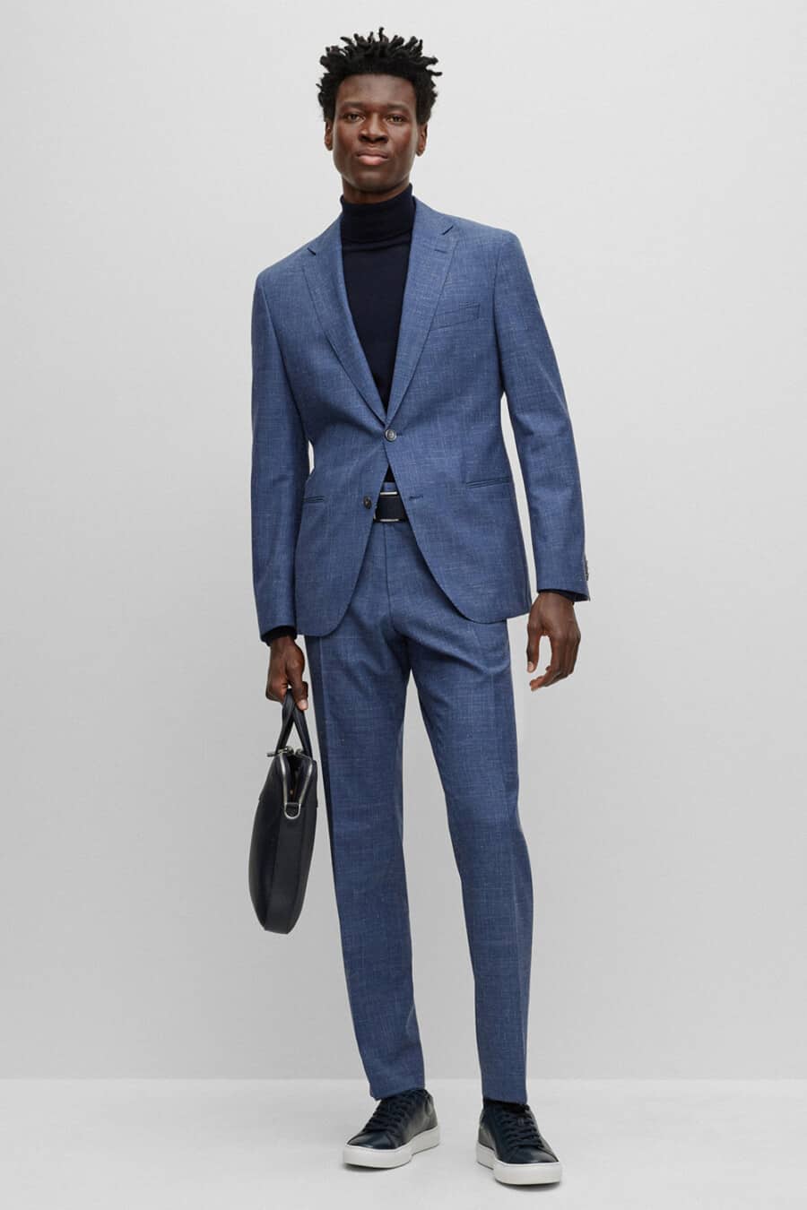 Men's mid blue suit, navy turtleneck, navy leather sneakers and navy leather briefcase outfit