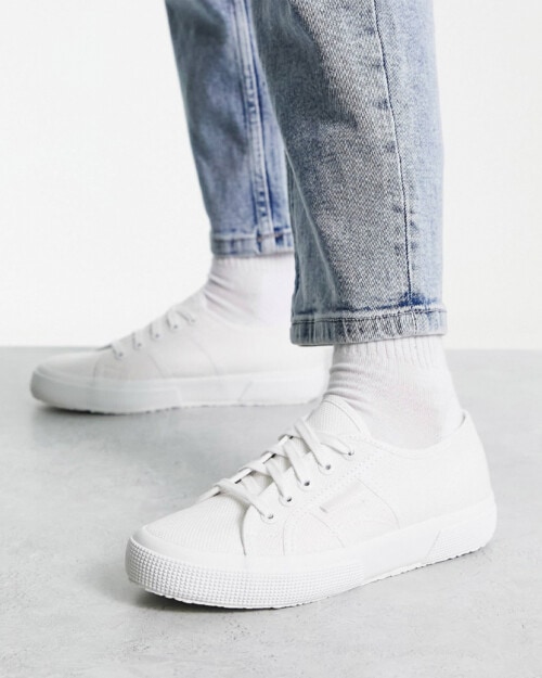 Superga Cotu Classic 2750 sneaker in white worn on feet with white socks and light wash jeans