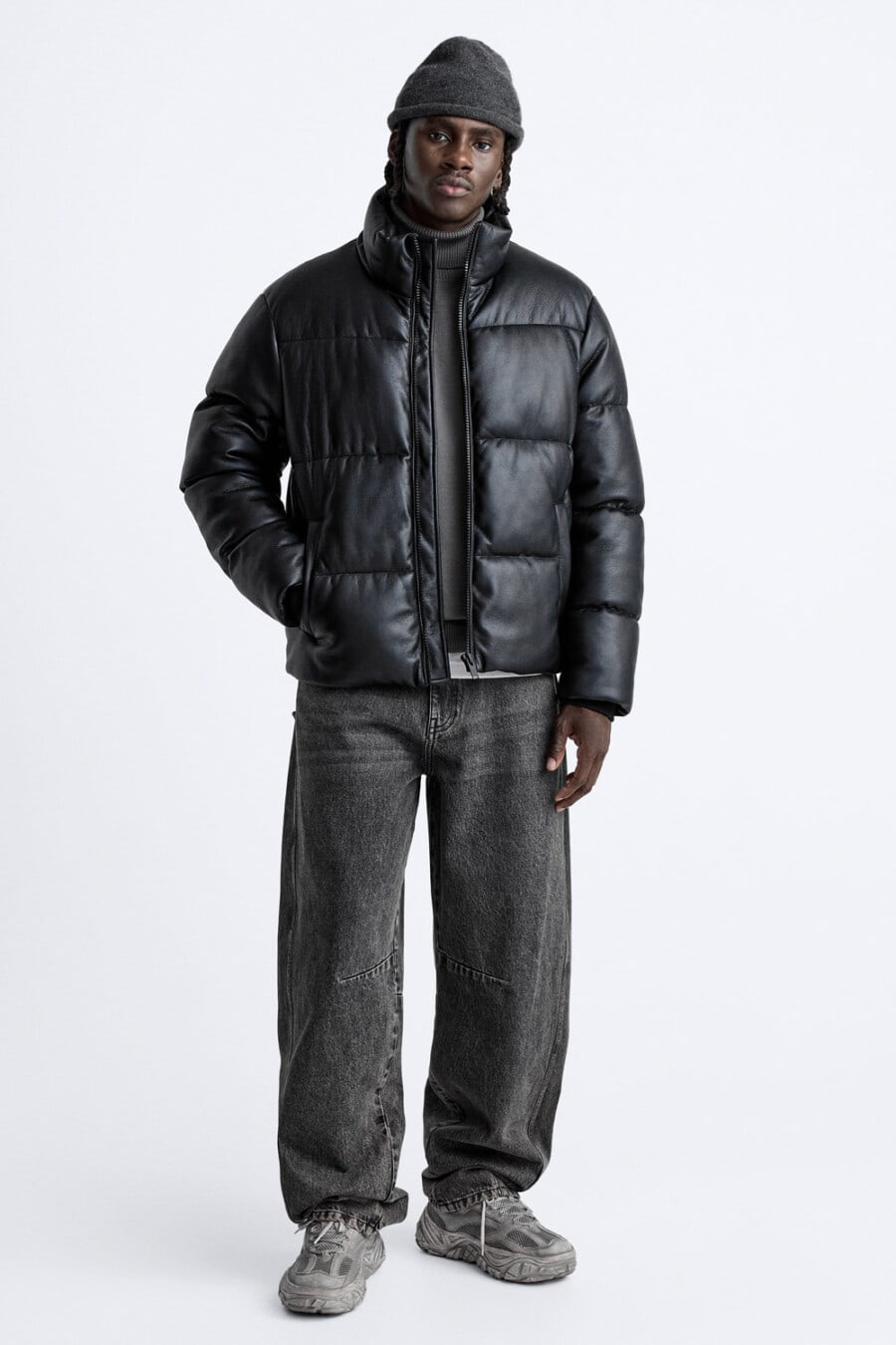Men's baggy black jeans, charcoal turtleneck, black puffer jacket, charcoal beanie and grey chunky sneakers outfit