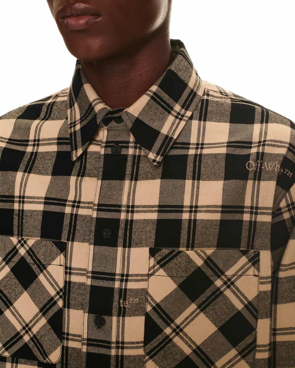 Close up of man wearing a black/beige check flannel shirt by OFF-WHITE